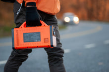 image of roadside worker carrying HIMCEN 450 portable power station